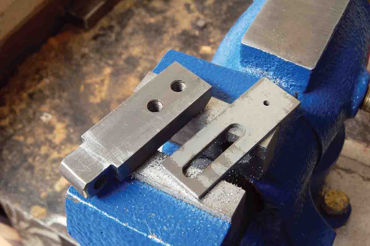 A complete base staff with screw holes for the elevator (left) and the elevator with adjustment slot and aperture complete.